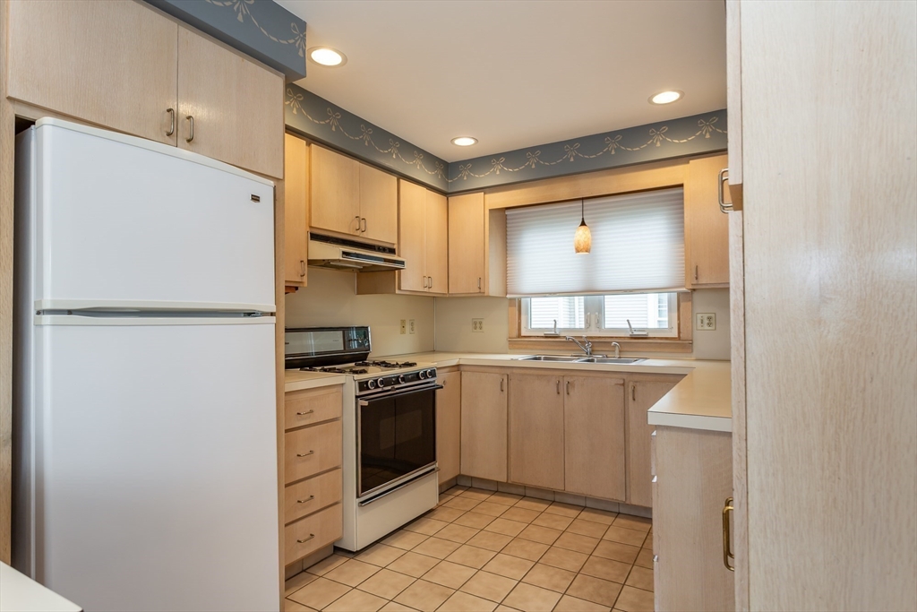 1895 Rodman Street Fall River, MA 02721 - Photo 11 of 26 a kitchen with stainless steel appliances granite countertop a refrigerator sink and stove