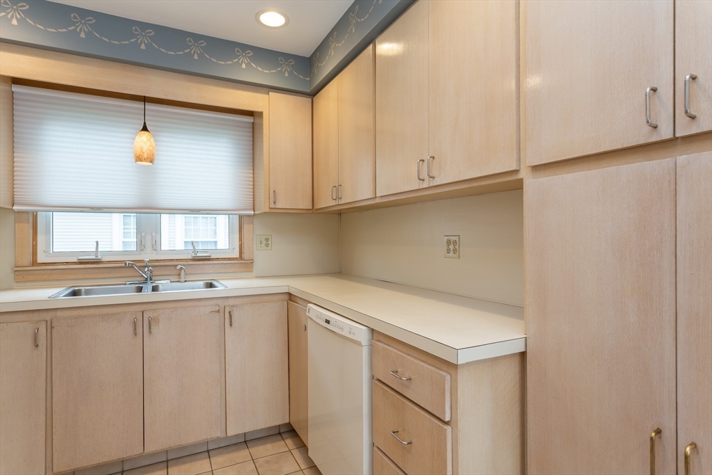 1895 Rodman Street Fall River, MA 02721 - Photo 12 of 26 a kitchen with white cabinets and sink