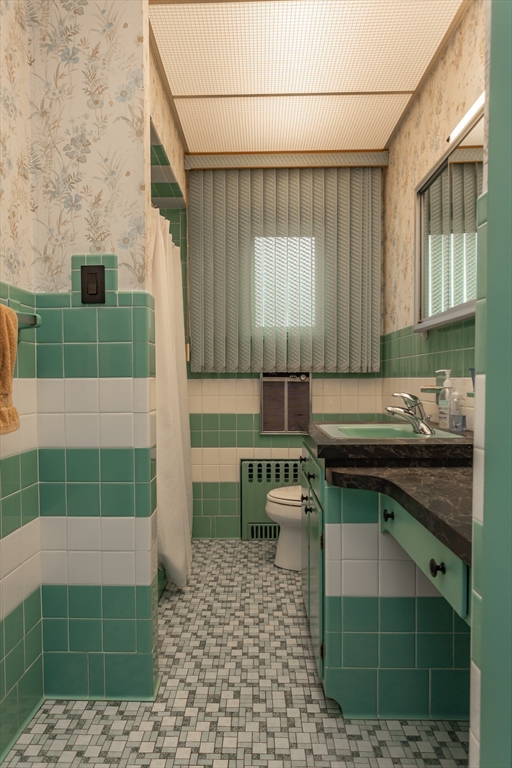 1895 Rodman Street Fall River, MA 02721 - Photo 23 of 26 a bathroom with a sink and a mirror