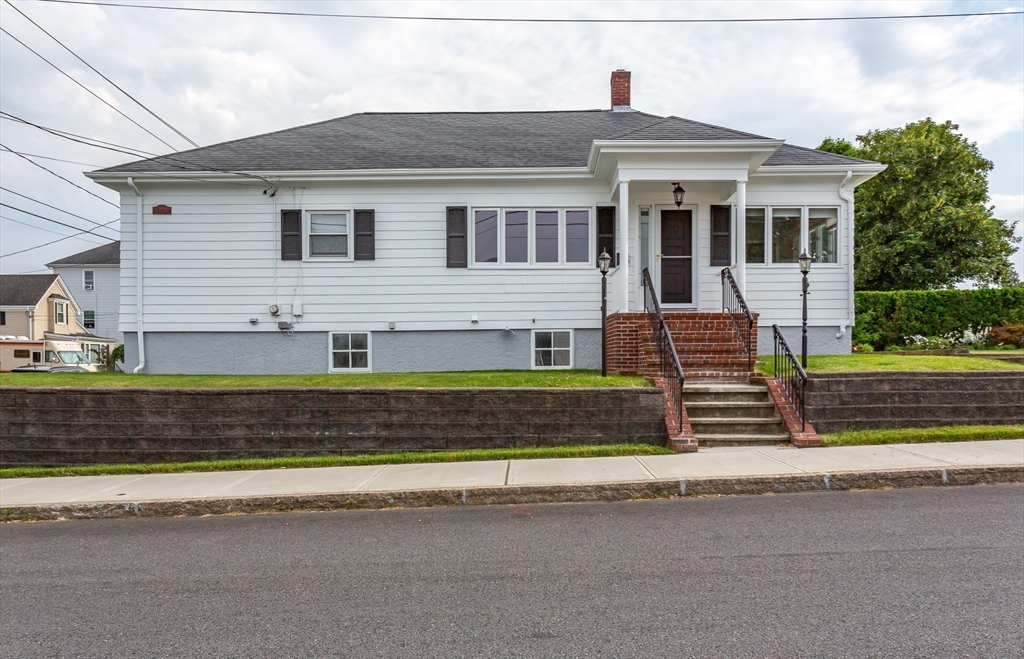 1895 Rodman Street Fall River, MA 02721 - Photo 3 of 26 a front view of a house with a small garden