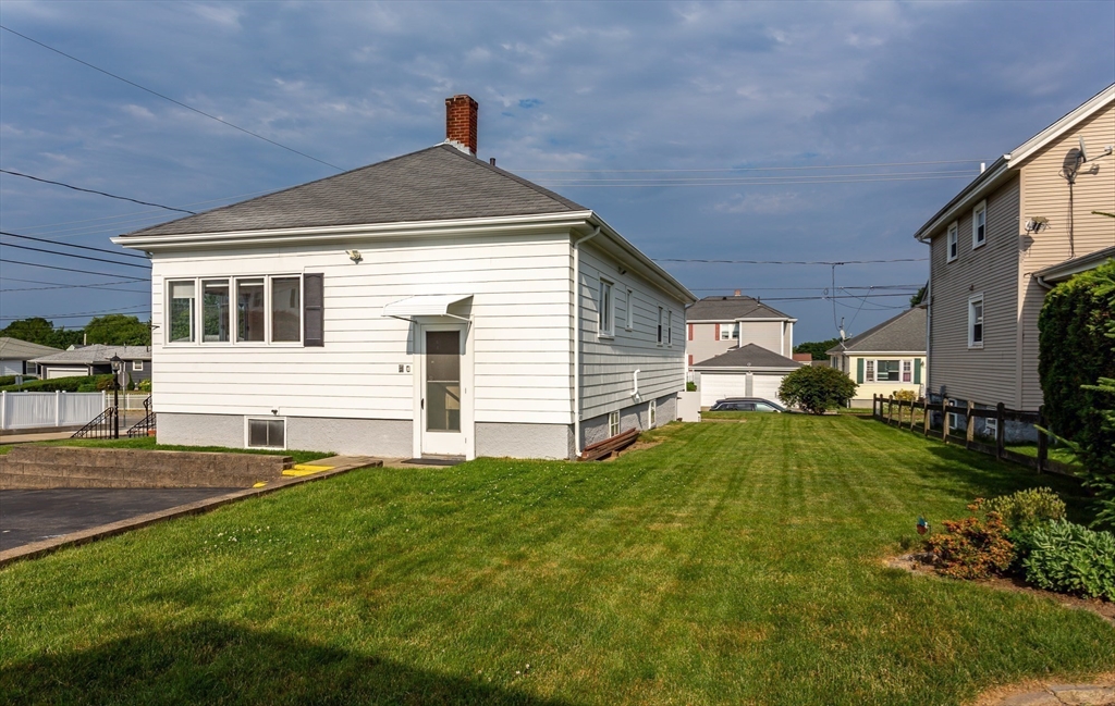 1895 Rodman Street Fall River, MA 02721 - Photo 6 of 26 a front view of a house with a yard