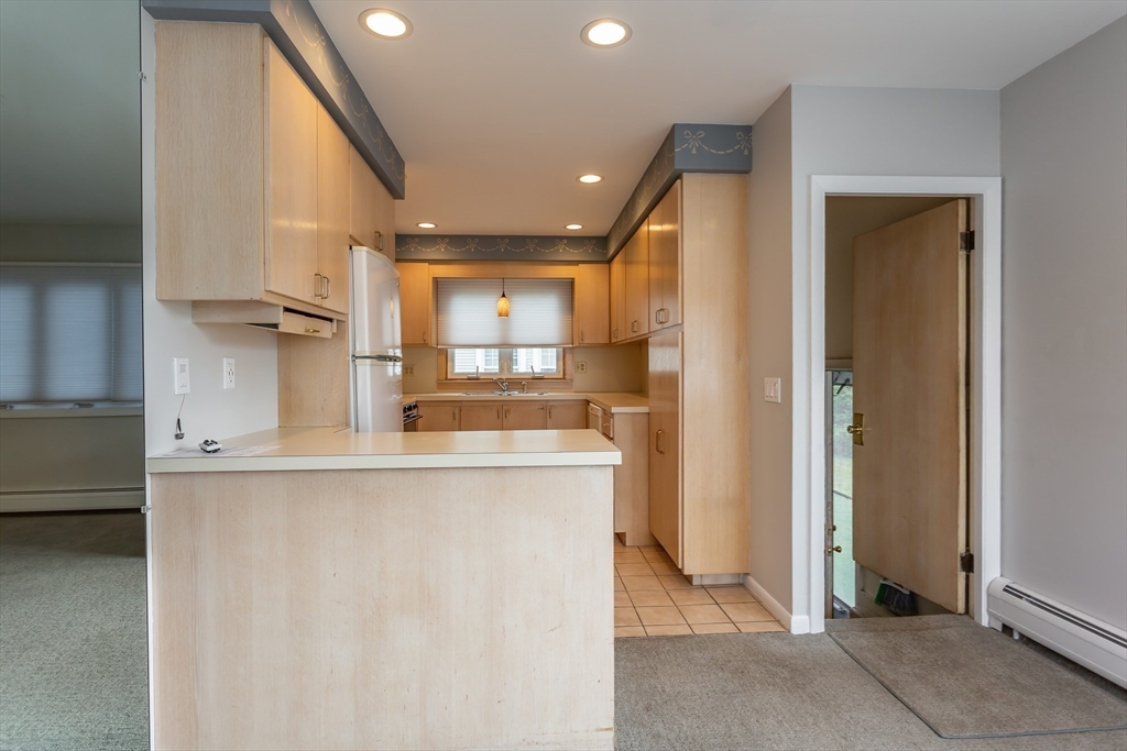 1895 Rodman Street Fall River, MA 02721 - Photo 10 of 26 a view of a kitchen with kitchen island a counter top space and appliances