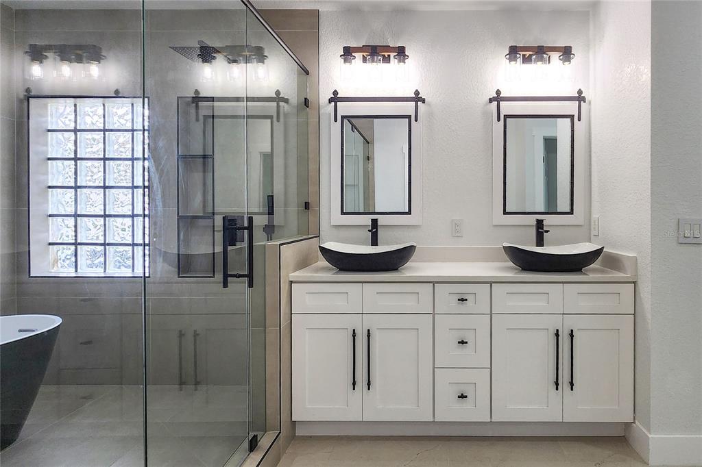 7027 Frascati Loop Wesley Chapel, FL 33544 - Photo 15 of 28 a bathroom with double sink and a mirror