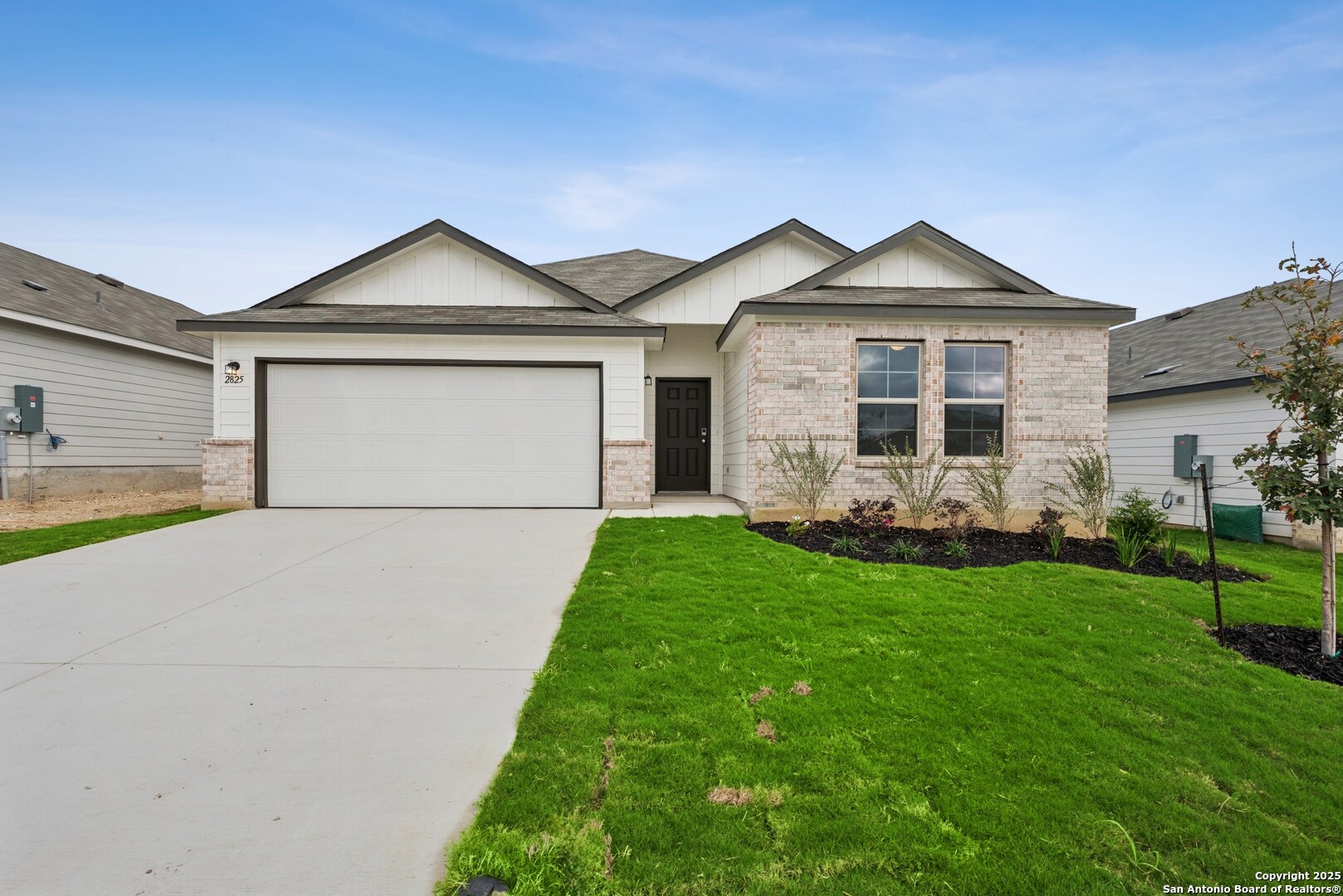 a front view of a house with a yard and garage