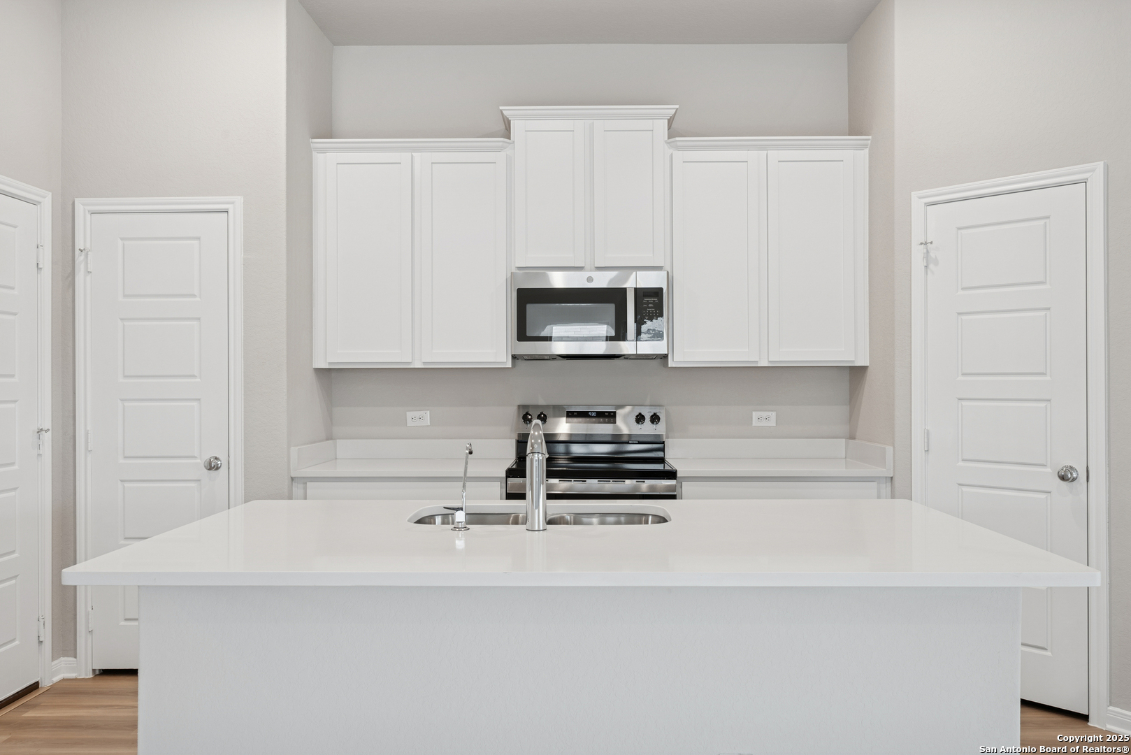 2825 Sun Bayou Seguin, TX 78155 - Photo 2 of 40 a kitchen with kitchen island a sink a stove and microwave