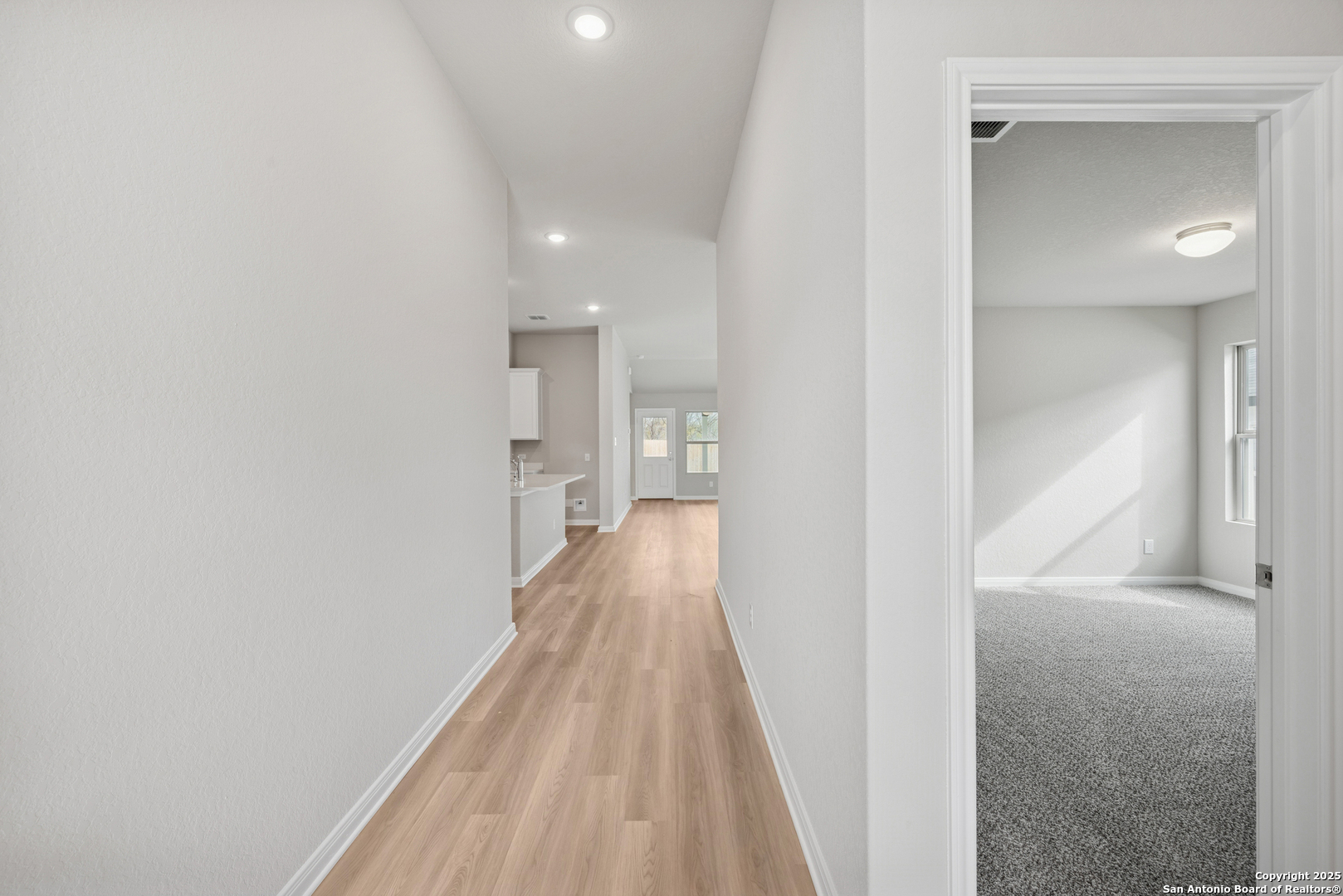 2825 Sun Bayou Seguin, TX 78155 - Photo 33 of 40 a view of a hallway with wooden floor and a bathroom