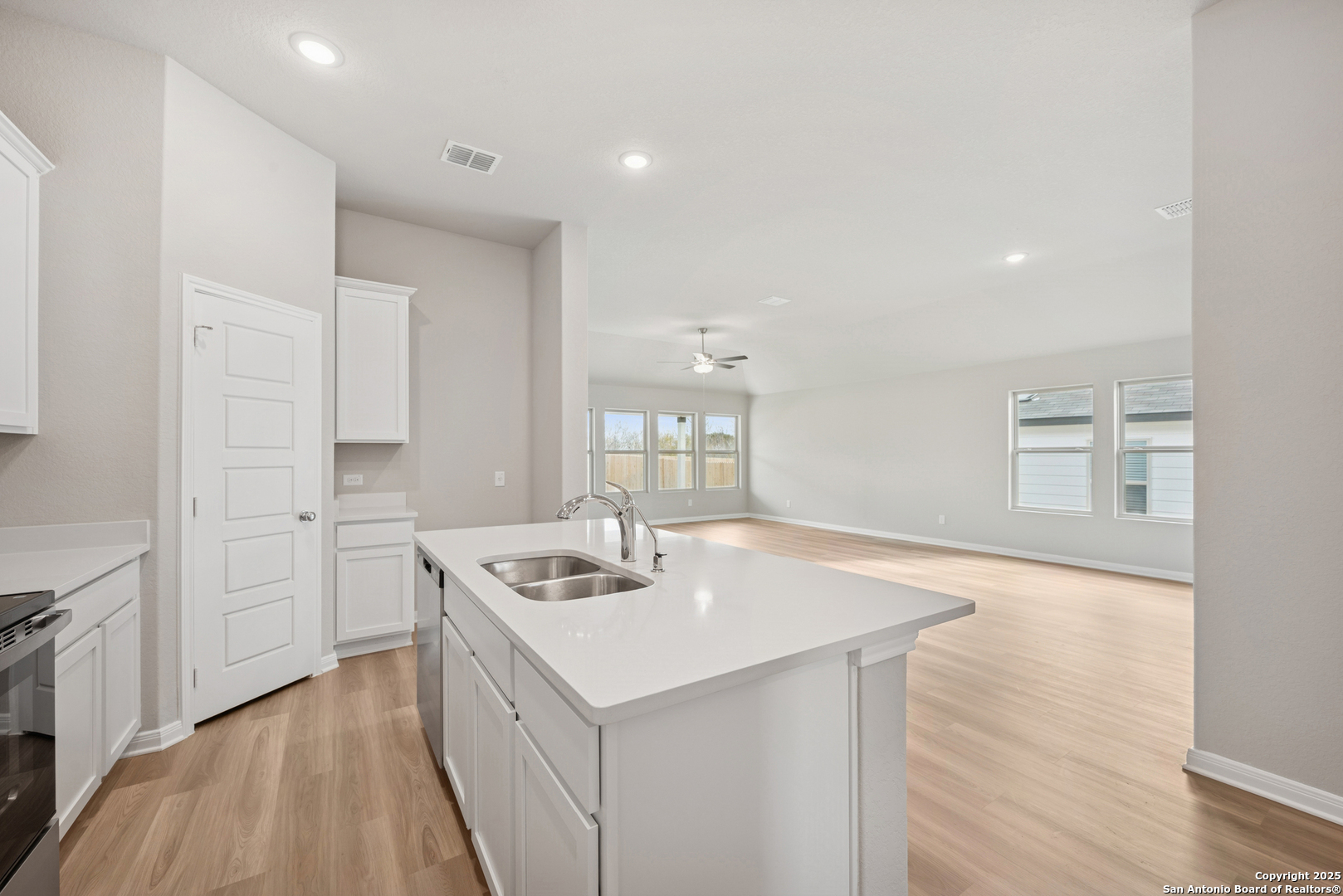 2825 Sun Bayou Seguin, TX 78155 - Photo 5 of 40 a kitchen that has a sink a stove and wooden floor
