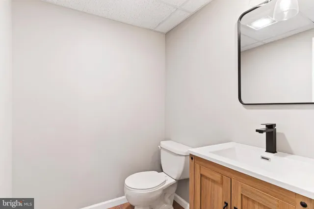 a white toilet sitting next to a bathroom sink