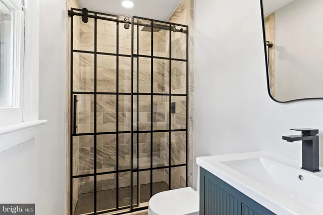 a bathroom with a sink toilet and mirror
