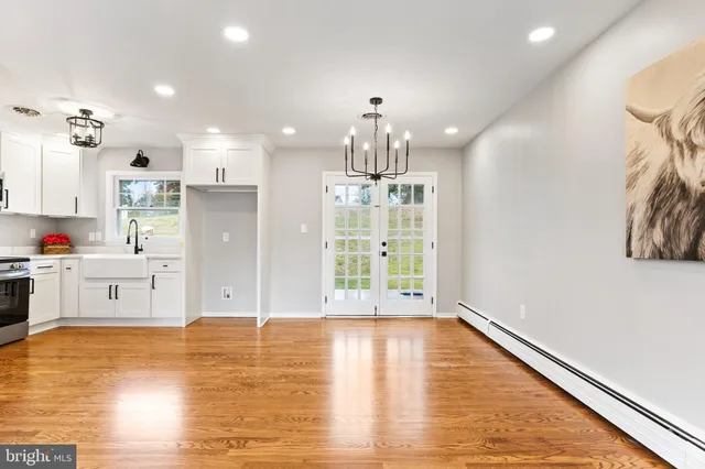 a kitchen with stainless steel appliances a refrigerator and a stove top oven
