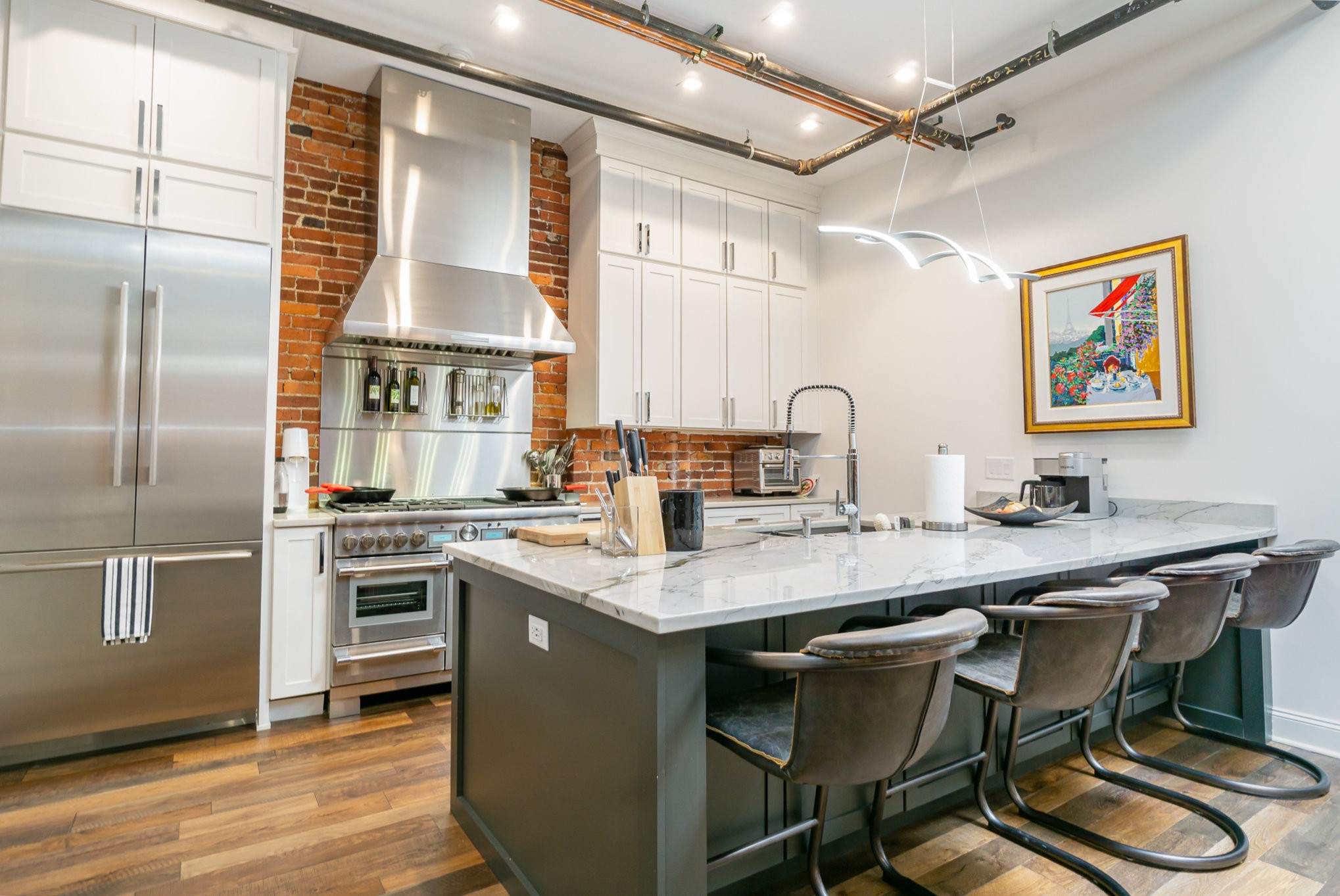 208 3rd Avenue North, Unit 500 Nashville, TN 37201 - Photo 1 of 42 a kitchen with stainless steel appliances granite countertop a stove refrigerator and cabinets