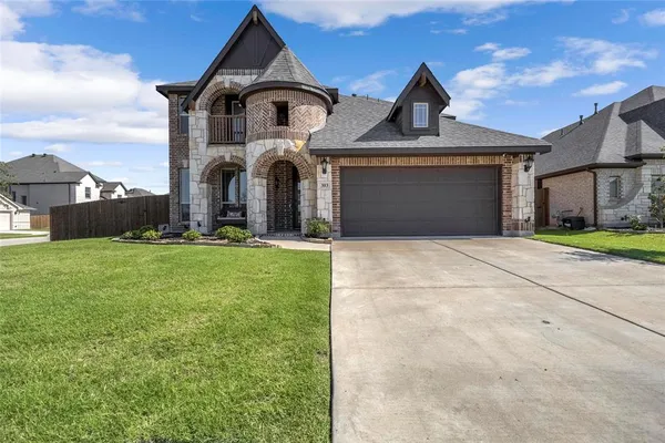a front view of a house with a yard and garage
