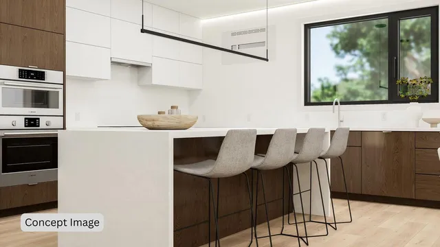 a kitchen with stainless steel appliances kitchen island granite countertop a table and a microwave