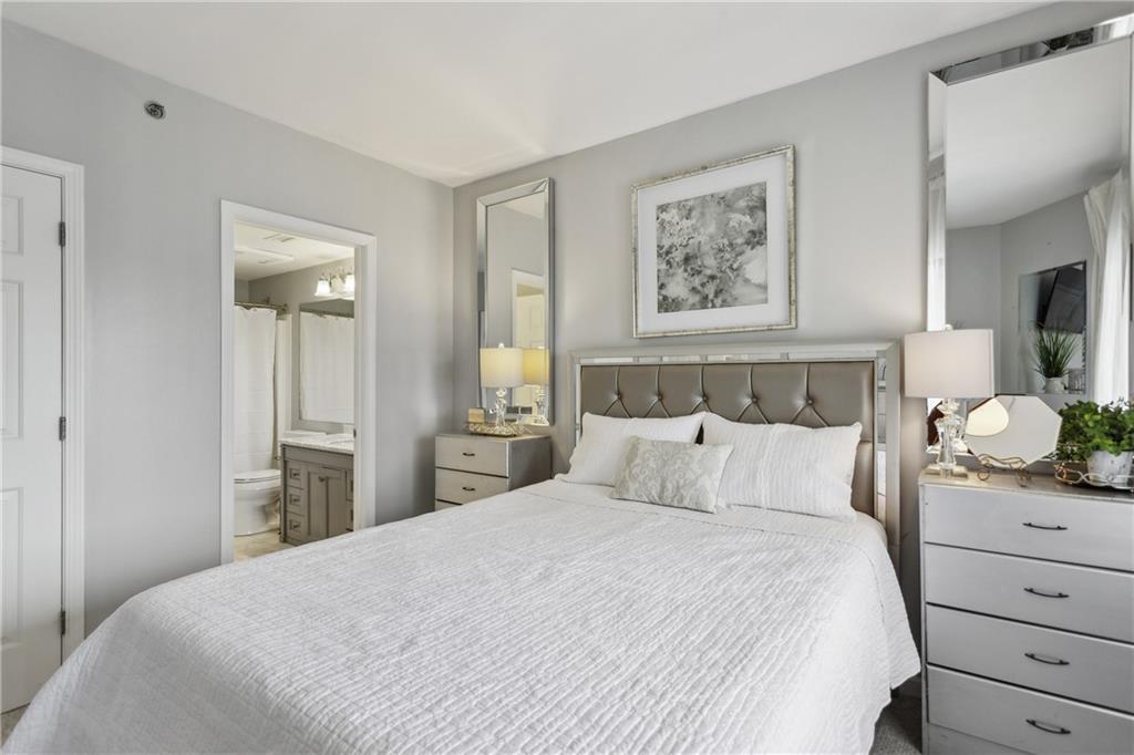 3481 Lakeside Drive Northeast, Unit 3004 Atlanta, GA 30326 - Photo 11 of 14 a bedroom with a bed and a chandelier