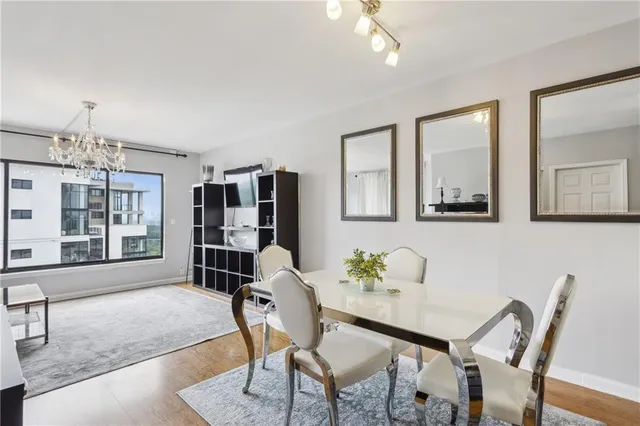 a workspace with furniture wooden floor and a chandelier