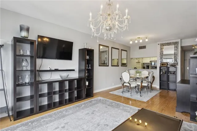 a view of a dining room with furniture a chandelier and wooden floor