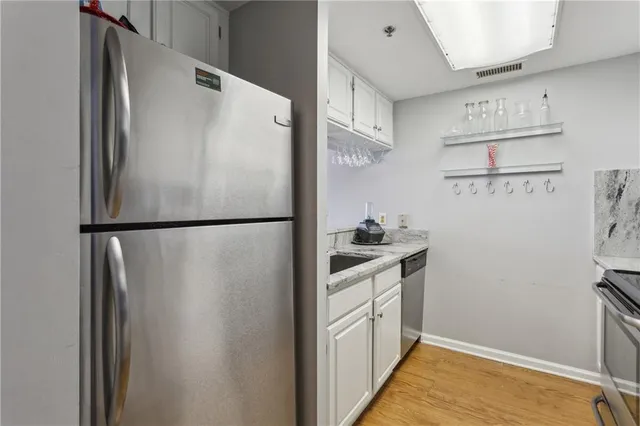 a kitchen with stainless steel appliances a refrigerator and cabinets