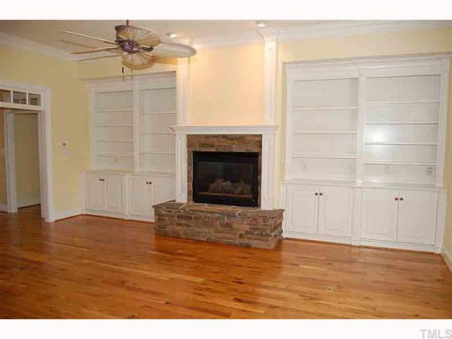 3105 Briar Stream Run Raleigh, NC 27612 - Photo 5 of 12 a view of empty room with wooden floor and fireplace