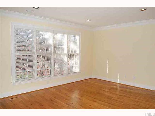 3105 Briar Stream Run Raleigh, NC 27612 - Photo 10 of 12 a view of an empty room with wooden floor and a window