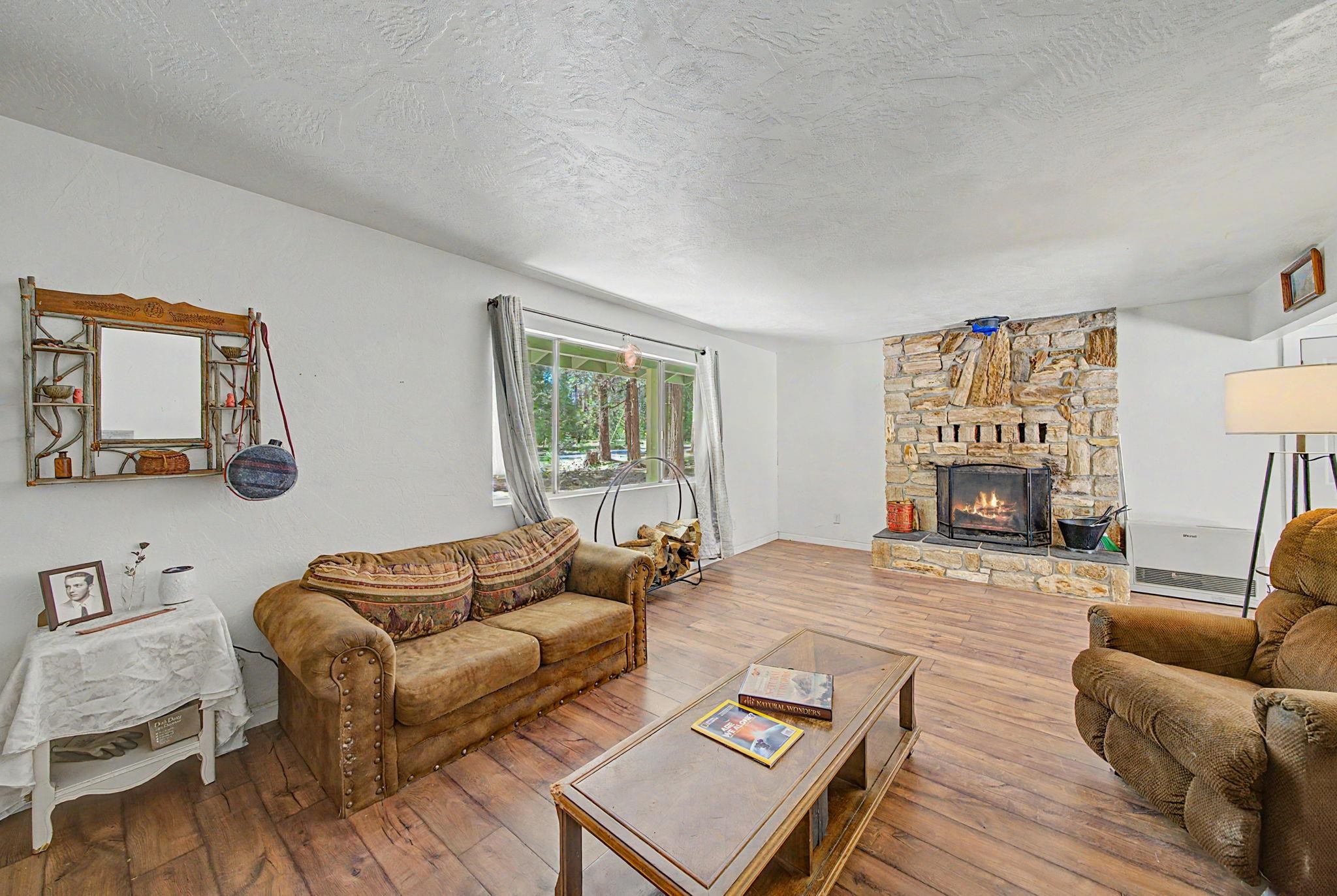 58374 Gill Ranch Road Cromberg, CA 96103 - Photo 34 of 44 a living room with furniture and a fireplace