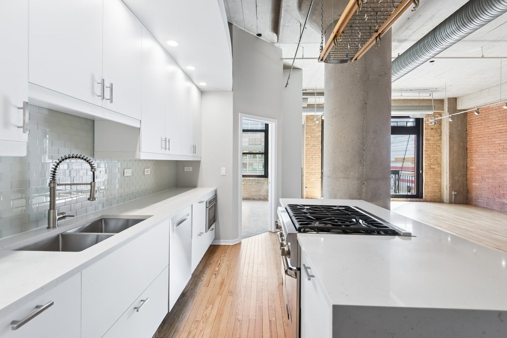 360 West Illinois Street, Unit 5F Chicago, IL 60654 - Photo 13 of 36 a kitchen with stainless steel appliances kitchen island a refrigerator sink and cabinets