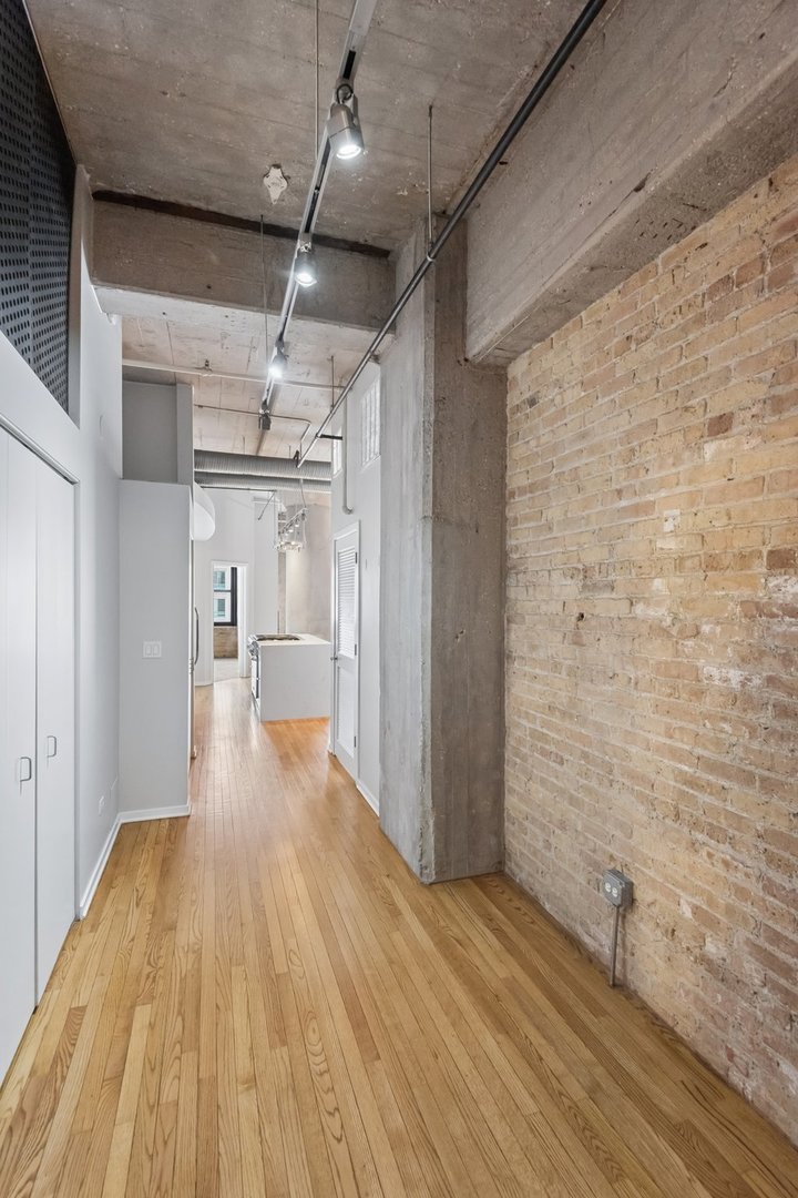 360 West Illinois Street, Unit 5F Chicago, IL 60654 - Photo 30 of 36 a view of a hallway with wooden floor