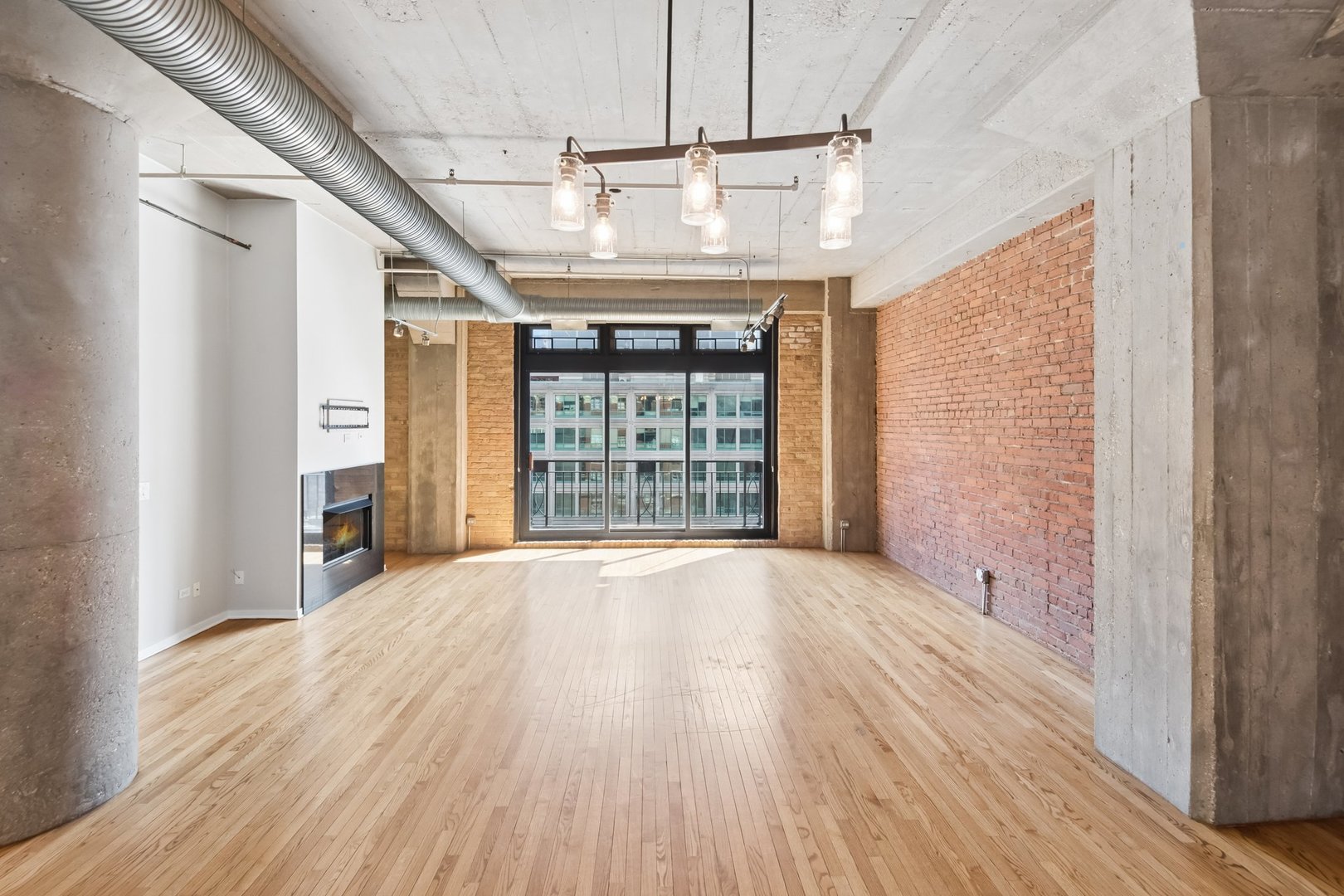360 West Illinois Street, Unit 5F Chicago, IL 60654 - Photo 3 of 36 a view of an empty room with wooden floor and a window