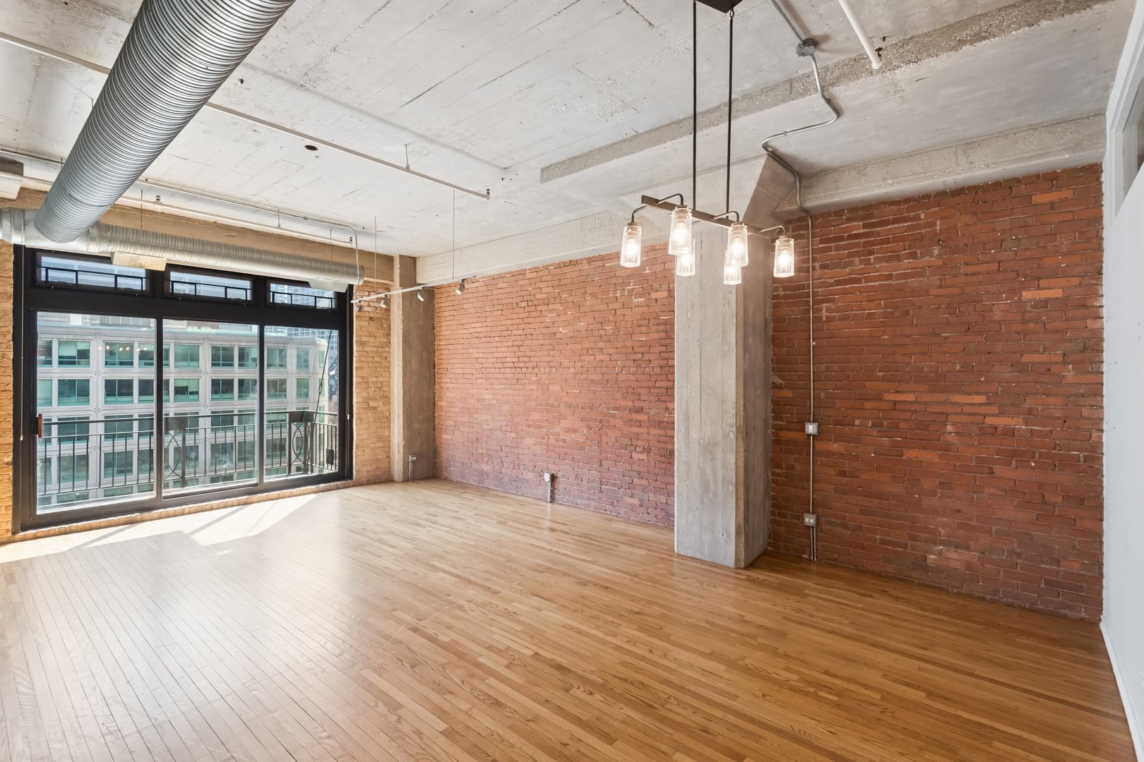 360 West Illinois Street, Unit 5F Chicago, IL 60654 - Photo 4 of 36 a view of empty room with wooden floor and fan