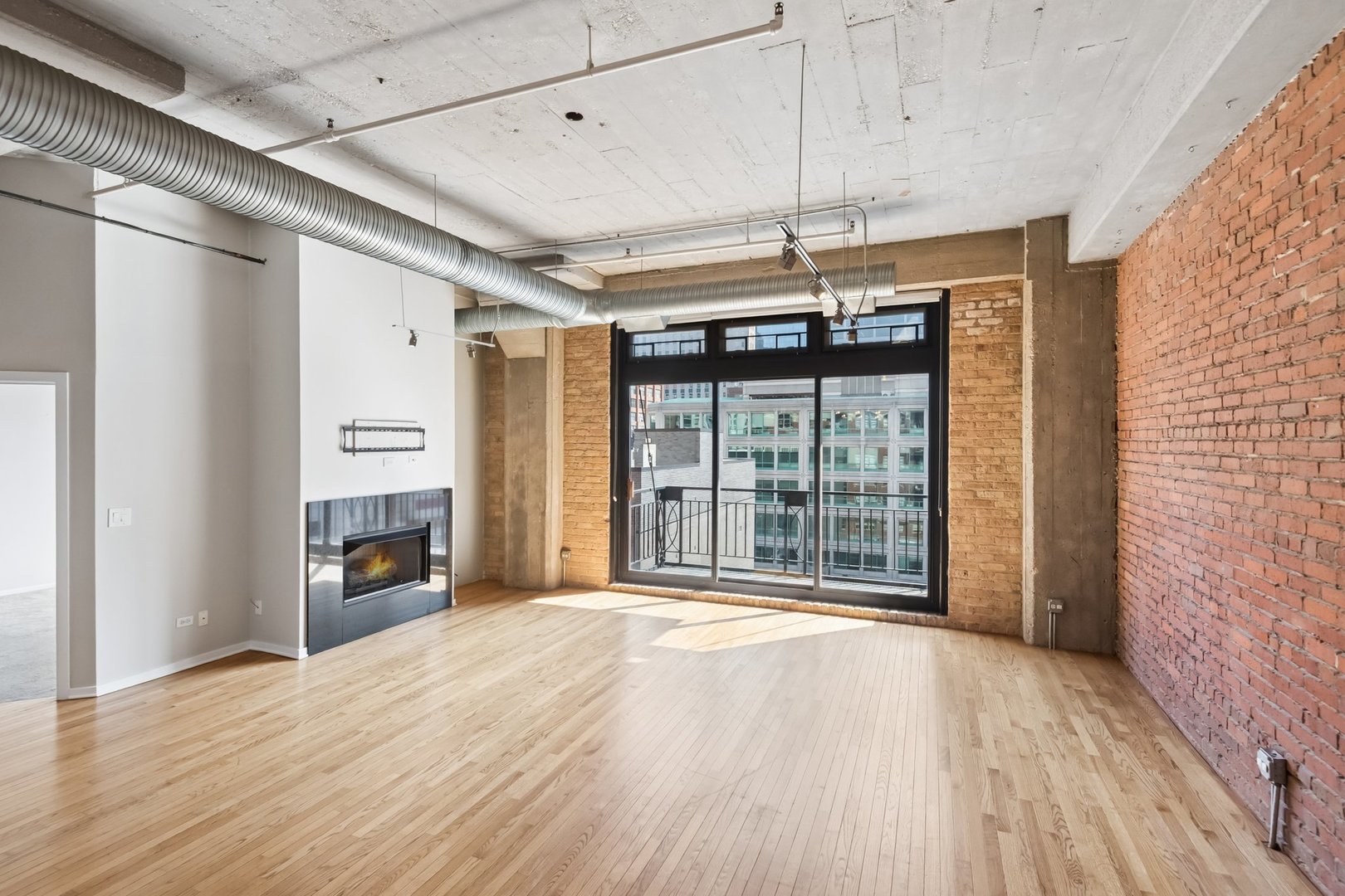 360 West Illinois Street, Unit 5F Chicago, IL 60654 - Photo 5 of 36 a view of an empty room with a fireplace and a window