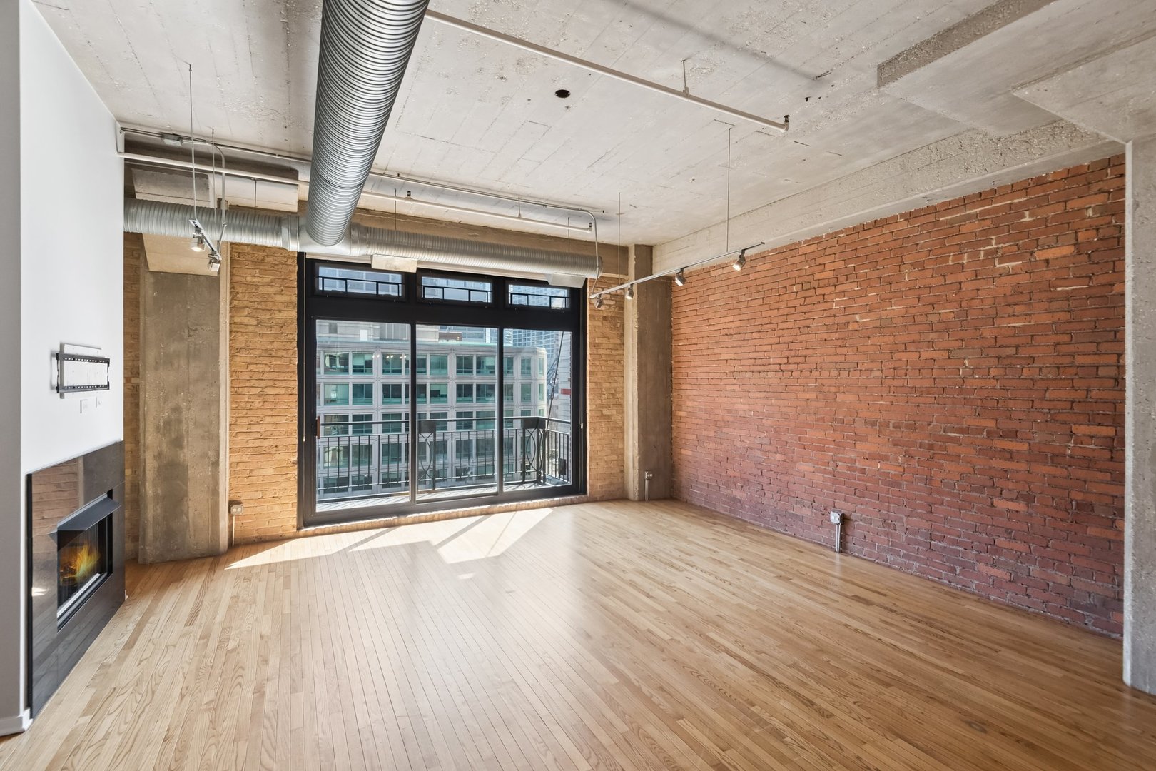 360 West Illinois Street, Unit 5F Chicago, IL 60654 - Photo 6 of 36 a view of an empty room with wooden floor and a window