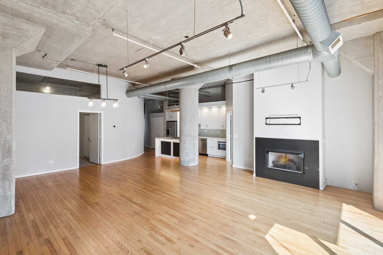 360 West Illinois Street, Unit 5F Chicago, IL 60654 - Photo 7 of 36 a view of an empty room with wooden floor fire place and windows