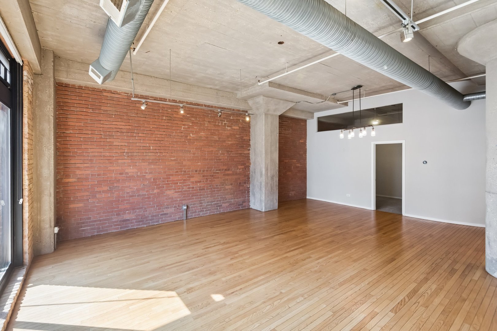 360 West Illinois Street, Unit 5F Chicago, IL 60654 - Photo 8 of 36 a view of empty room with wooden floor