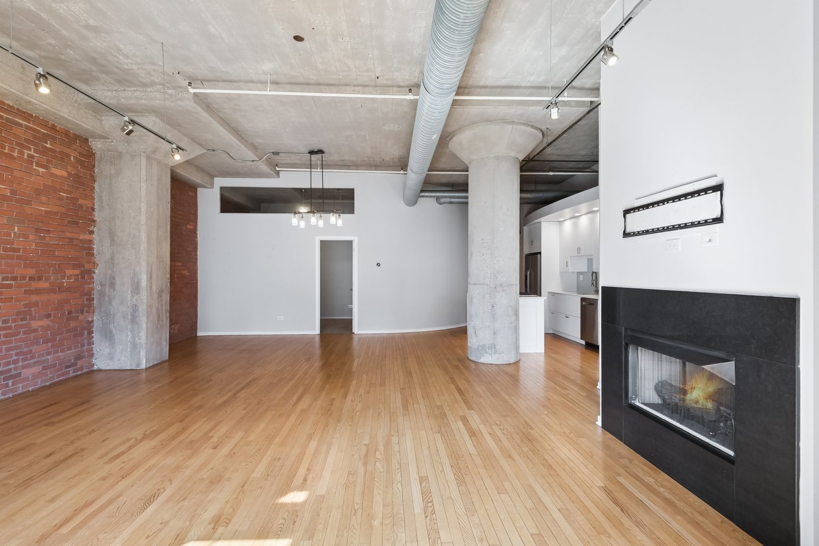 360 West Illinois Street, Unit 5F Chicago, IL 60654 - Photo 9 of 36 a view of hallway with wooden floor and fireplace