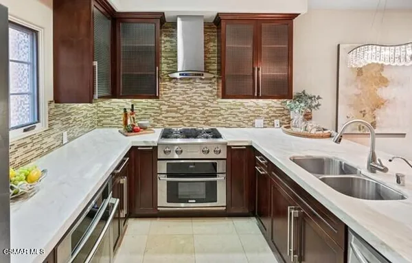 a kitchen with a sink stove and cabinets