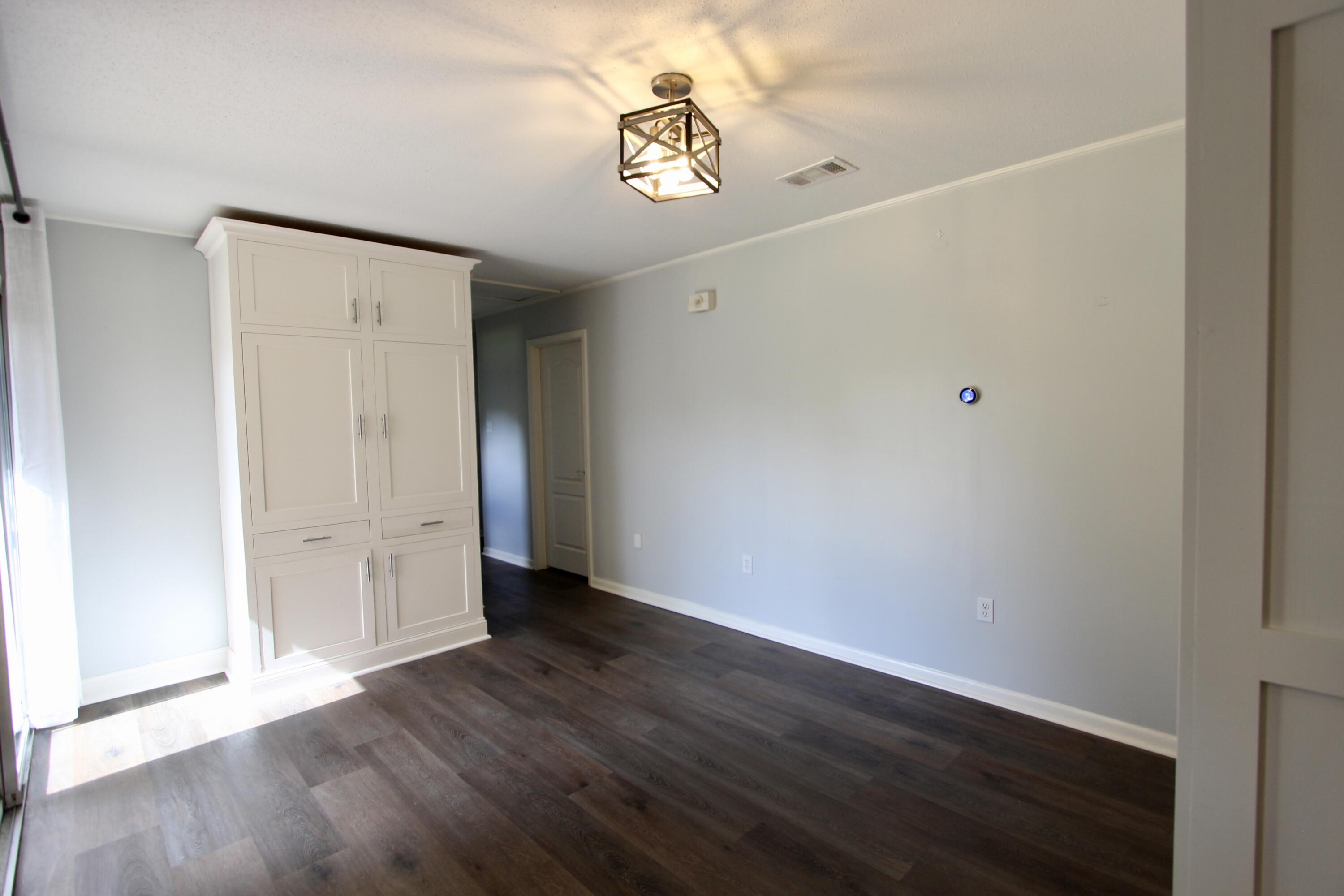 35 Birch Avenue Shalimar, FL 32579 - Photo 13 of 35 a view of an empty room with wooden floor
