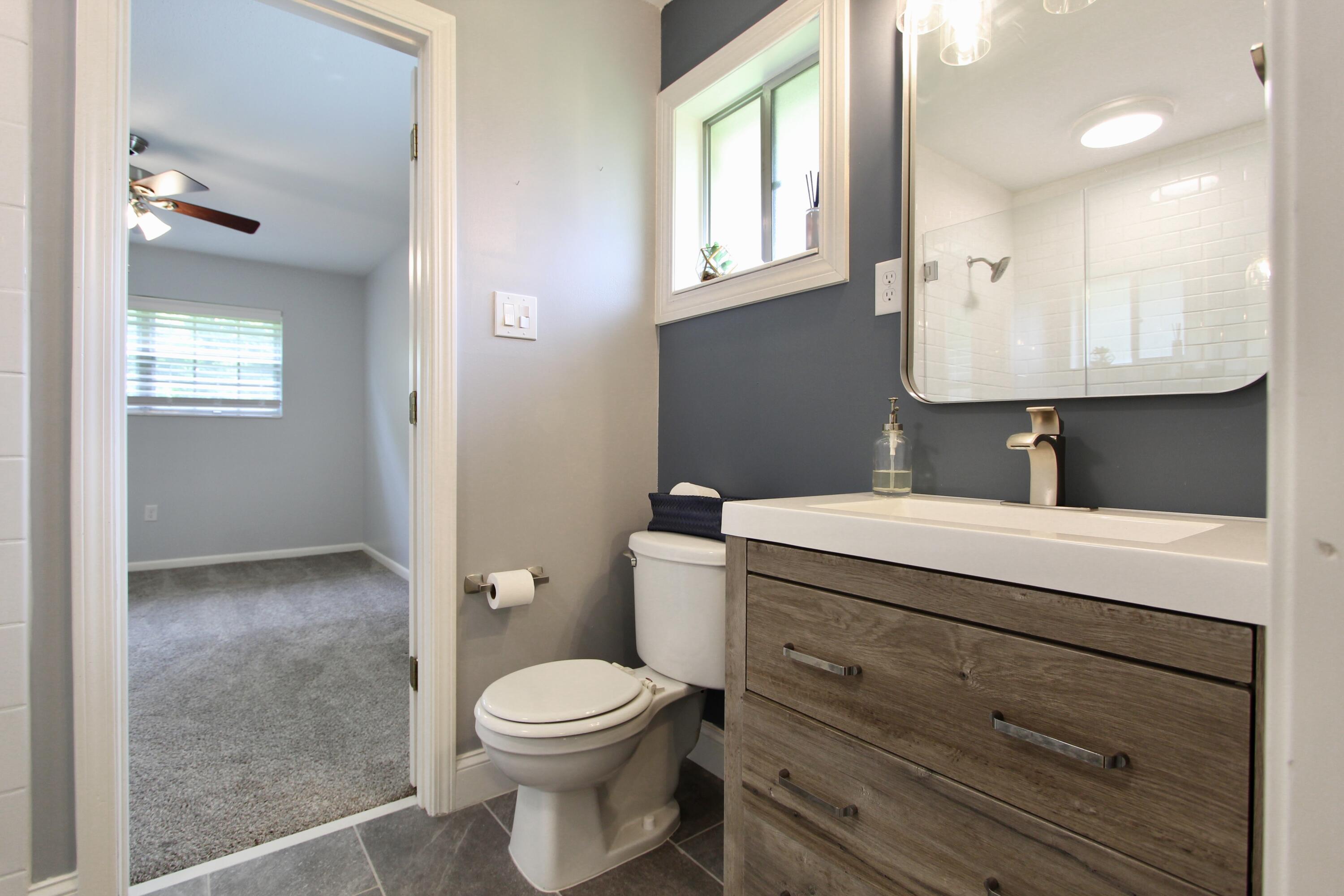 35 Birch Avenue Shalimar, FL 32579 - Photo 17 of 35 a bathroom with a toilet a sink and mirror