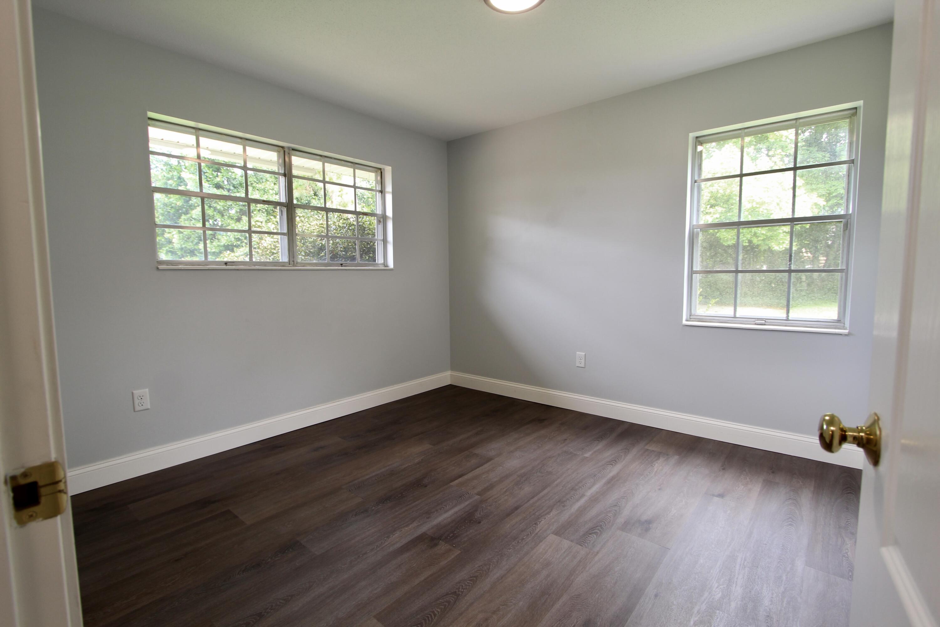 35 Birch Avenue Shalimar, FL 32579 - Photo 20 of 35 an empty room with wooden floor and windows