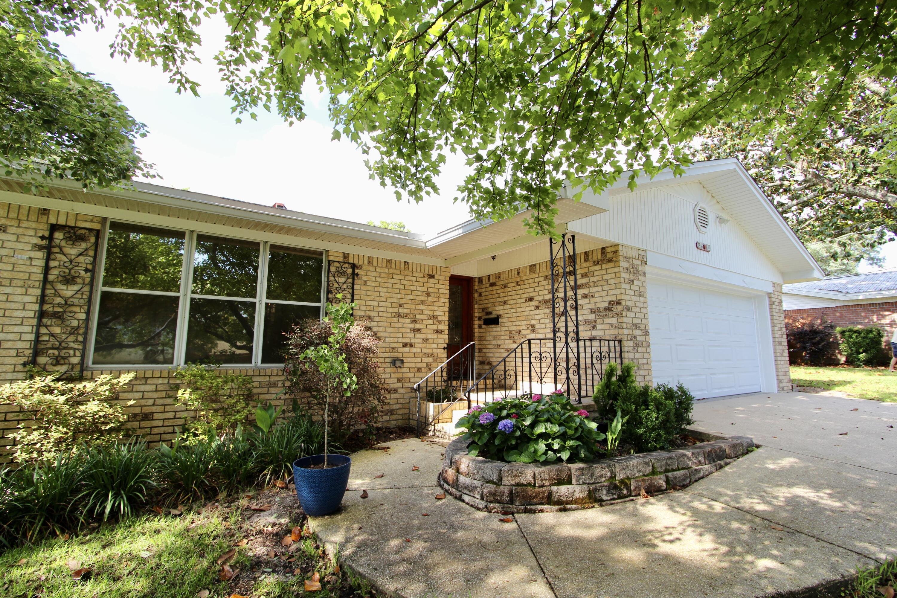 35 Birch Avenue Shalimar, FL 32579 - Photo 2 of 35 a front view of a house with a garden