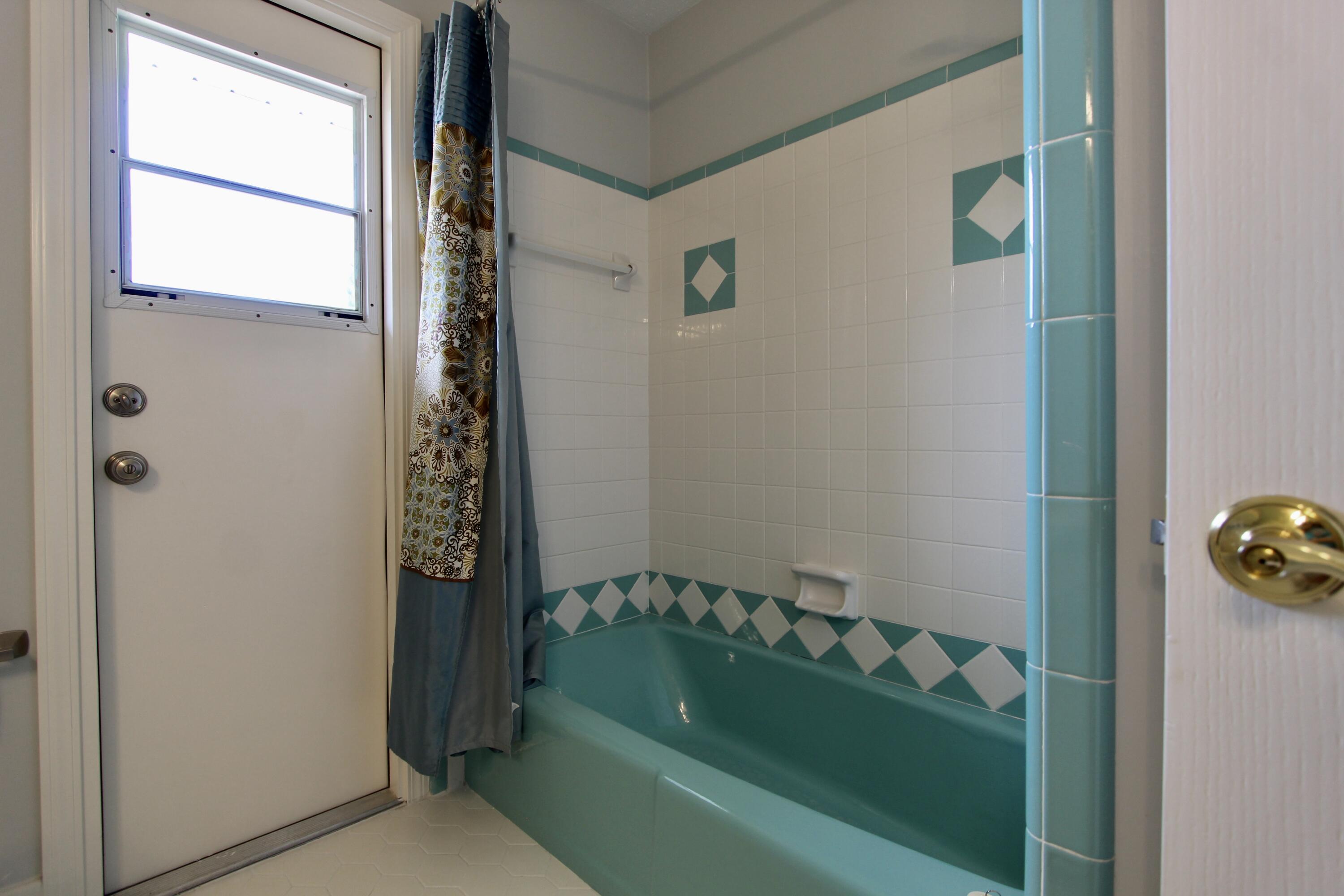 35 Birch Avenue Shalimar, FL 32579 - Photo 22 of 35 a bathroom with a tub and shower curtain