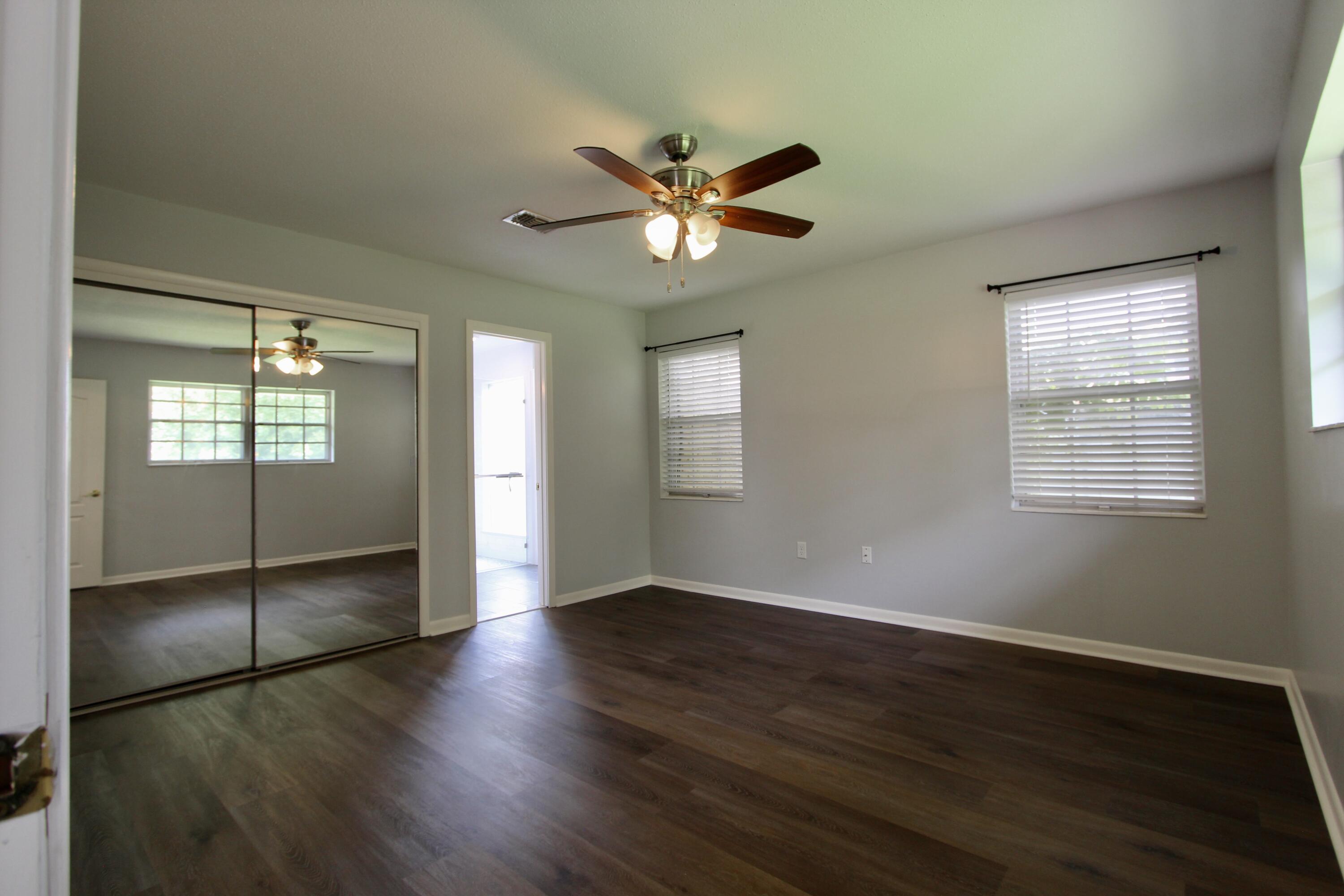 35 Birch Avenue Shalimar, FL 32579 - Photo 23 of 35 a view of an empty room with window and wooden floor