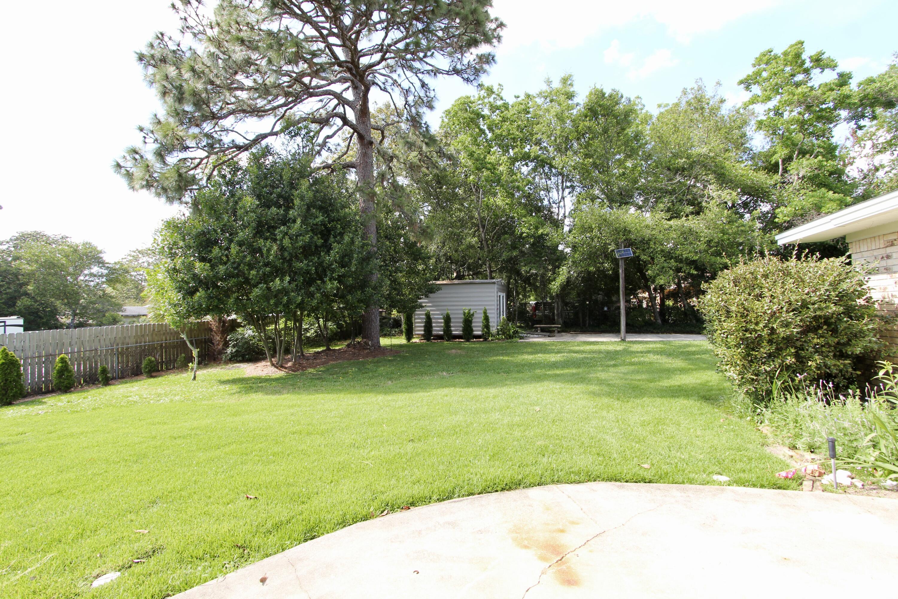 35 Birch Avenue Shalimar, FL 32579 - Photo 27 of 35 a front view of a house with garden