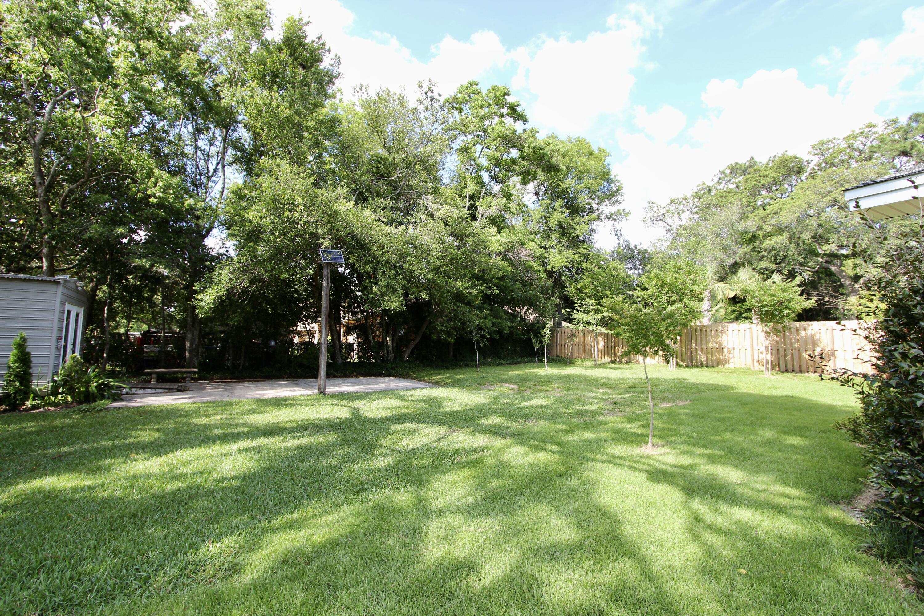 35 Birch Avenue Shalimar, FL 32579 - Photo 28 of 35 a grassy field with trees in the background