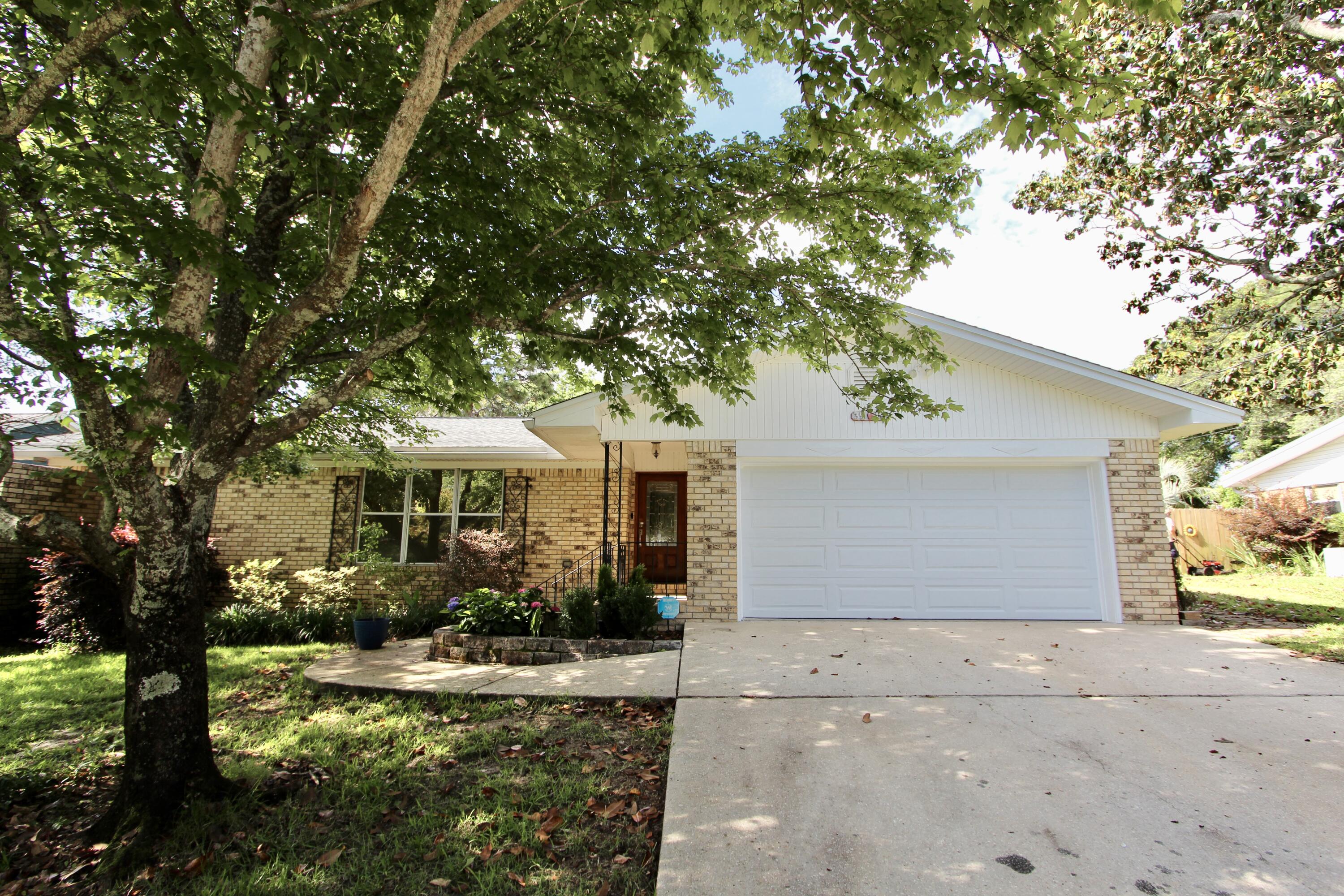 35 Birch Avenue Shalimar, FL 32579 - Photo 3 of 35 a front view of a house with garden