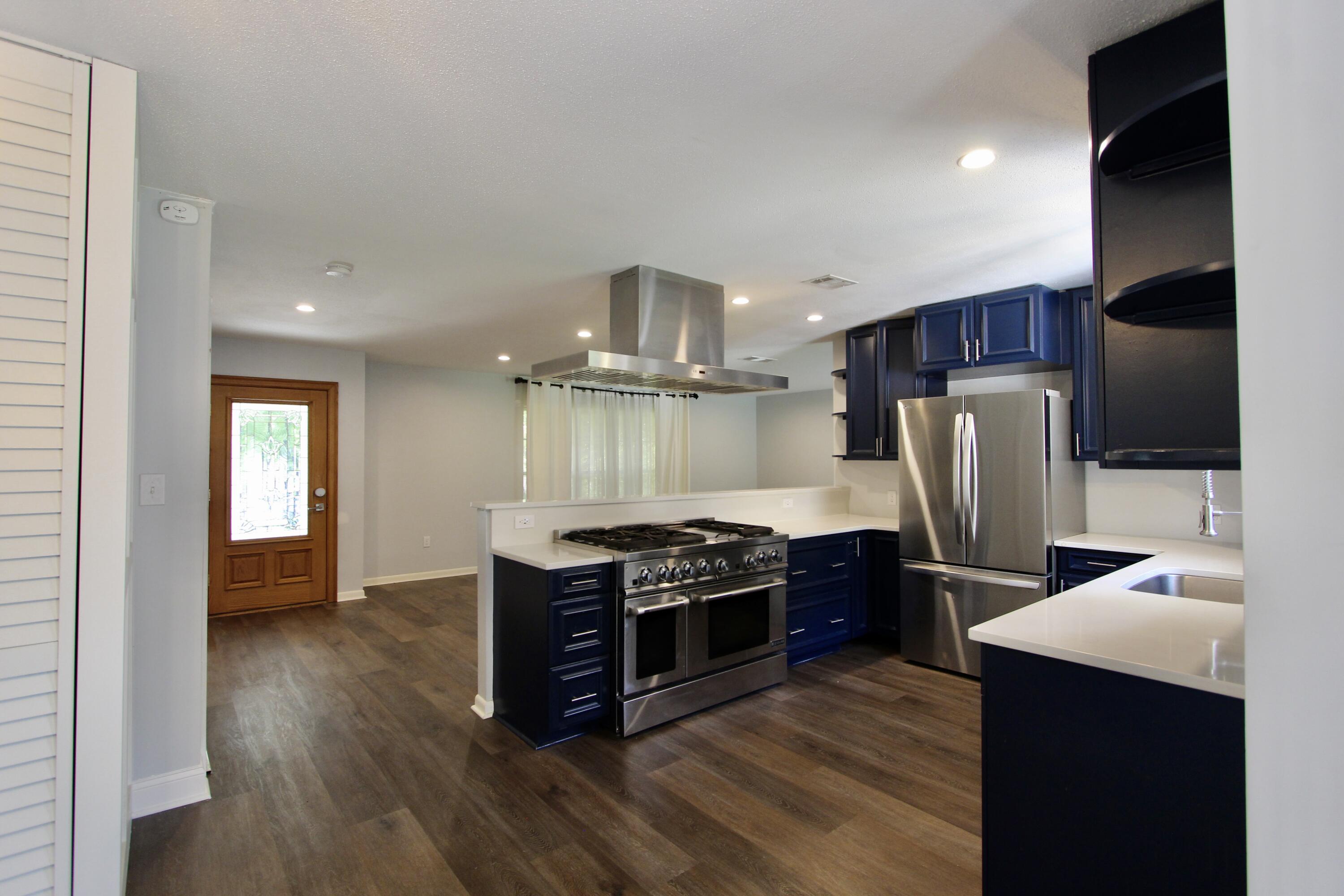 35 Birch Avenue Shalimar, FL 32579 - Photo 7 of 35 a kitchen with stainless steel appliances granite countertop a refrigerator a stove and a sink