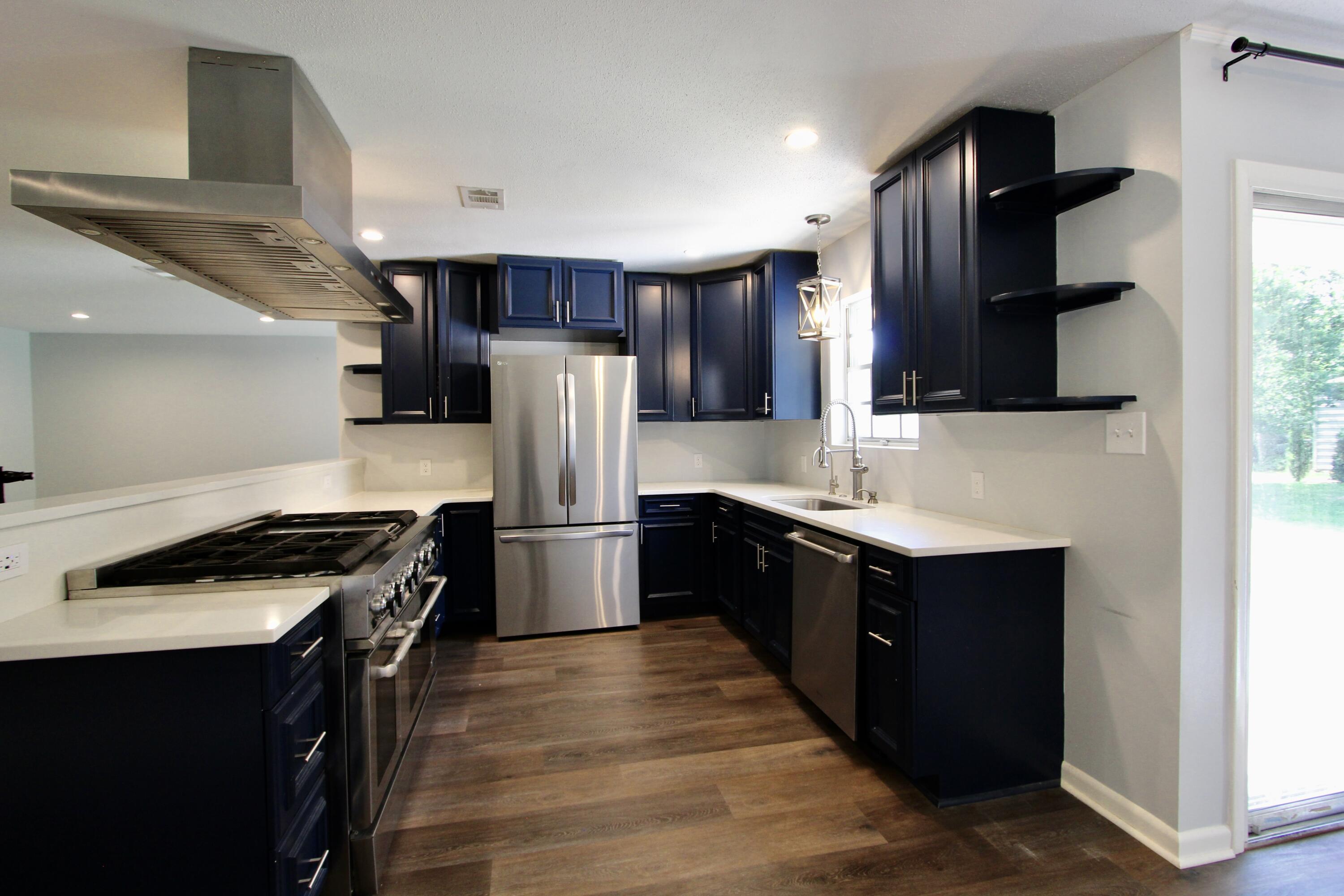 35 Birch Avenue Shalimar, FL 32579 - Photo 8 of 35 a kitchen with stainless steel appliances a refrigerator a sink a stove and cabinets