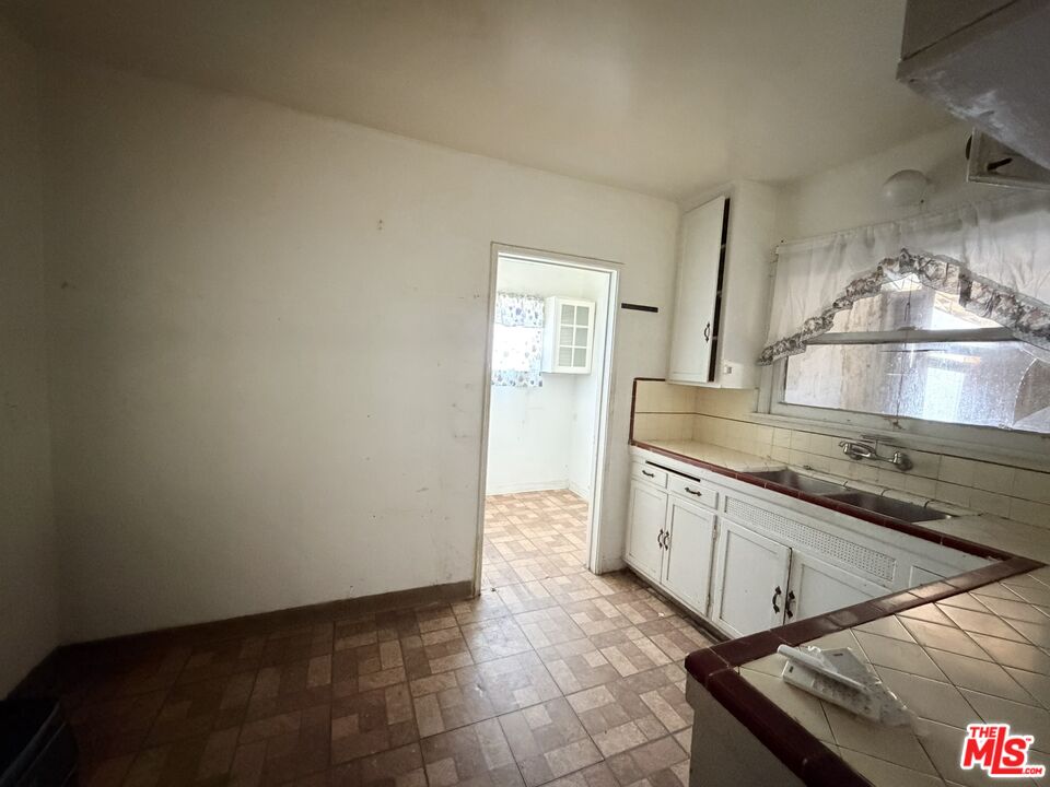 12918 Shreve Road Whittier, CA 90602 - Photo 39 of 42 a large kitchen with granite countertop a sink and a stove