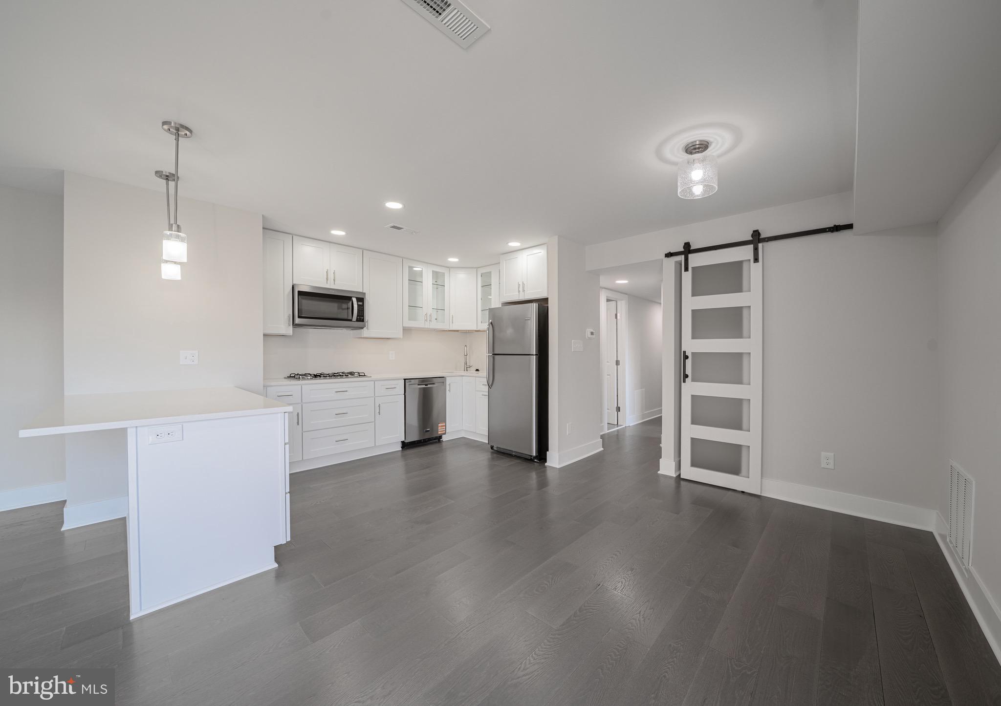 3122 Brinkley Road, Unit 102 Temple Hills, MD 20748 - Photo 12 of 44 a view of kitchen with wooden floor and electronic appliances