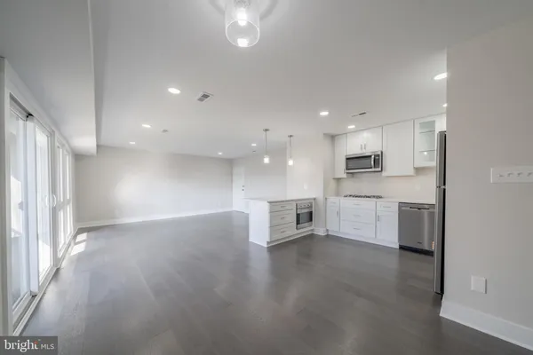 a view of kitchen with cabinets and wooden floor