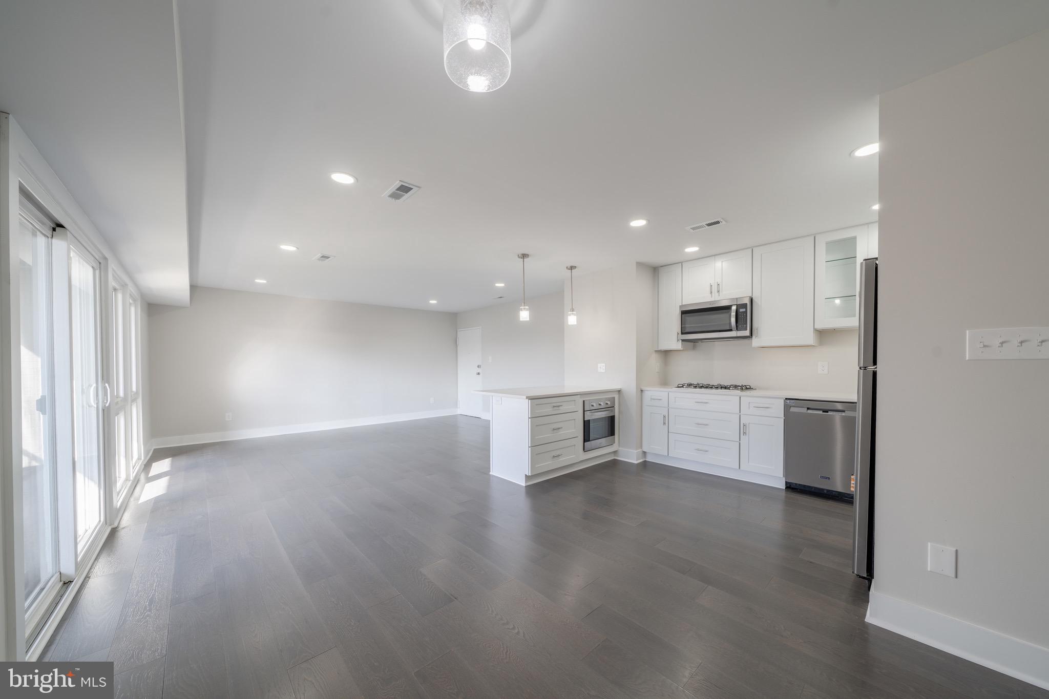 3122 Brinkley Road, Unit 102 Temple Hills, MD 20748 - Photo 13 of 44 a view of kitchen with cabinets and wooden floor