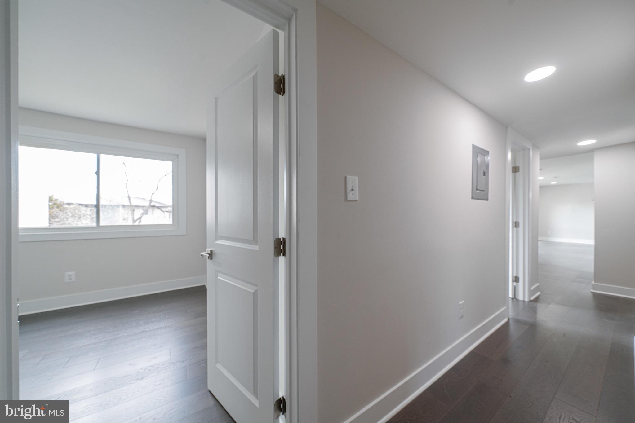 3122 Brinkley Road, Unit 102 Temple Hills, MD 20748 - Photo 24 of 44 a view of an empty room with wooden floor and a window